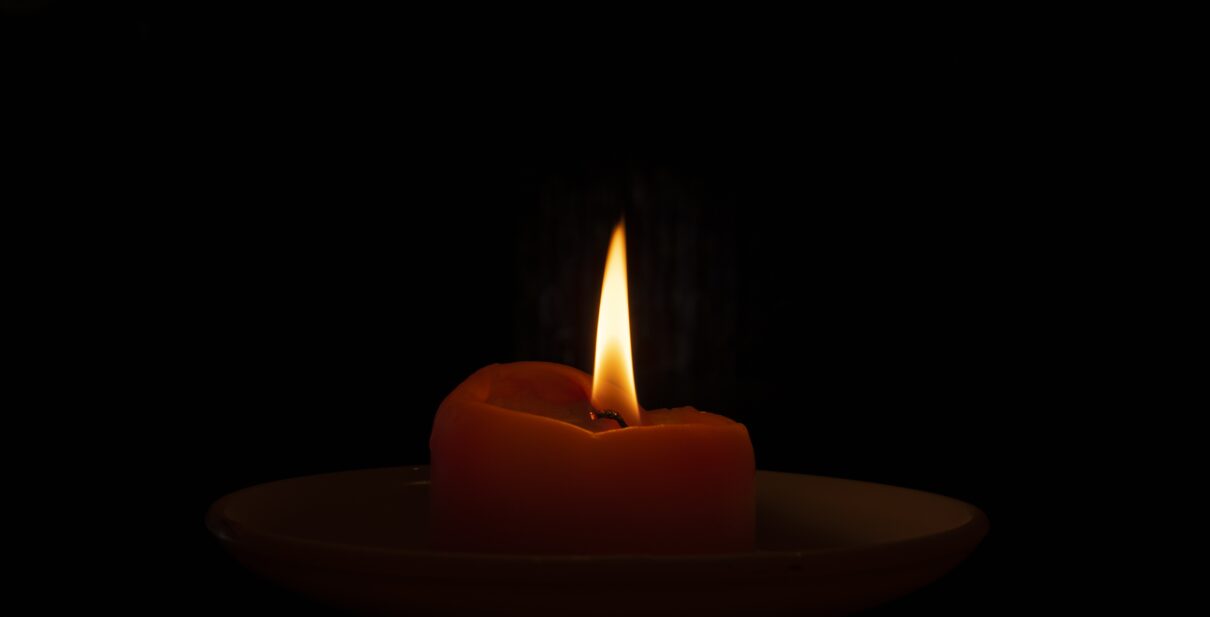 Closeup shot of a burning candle in the dark